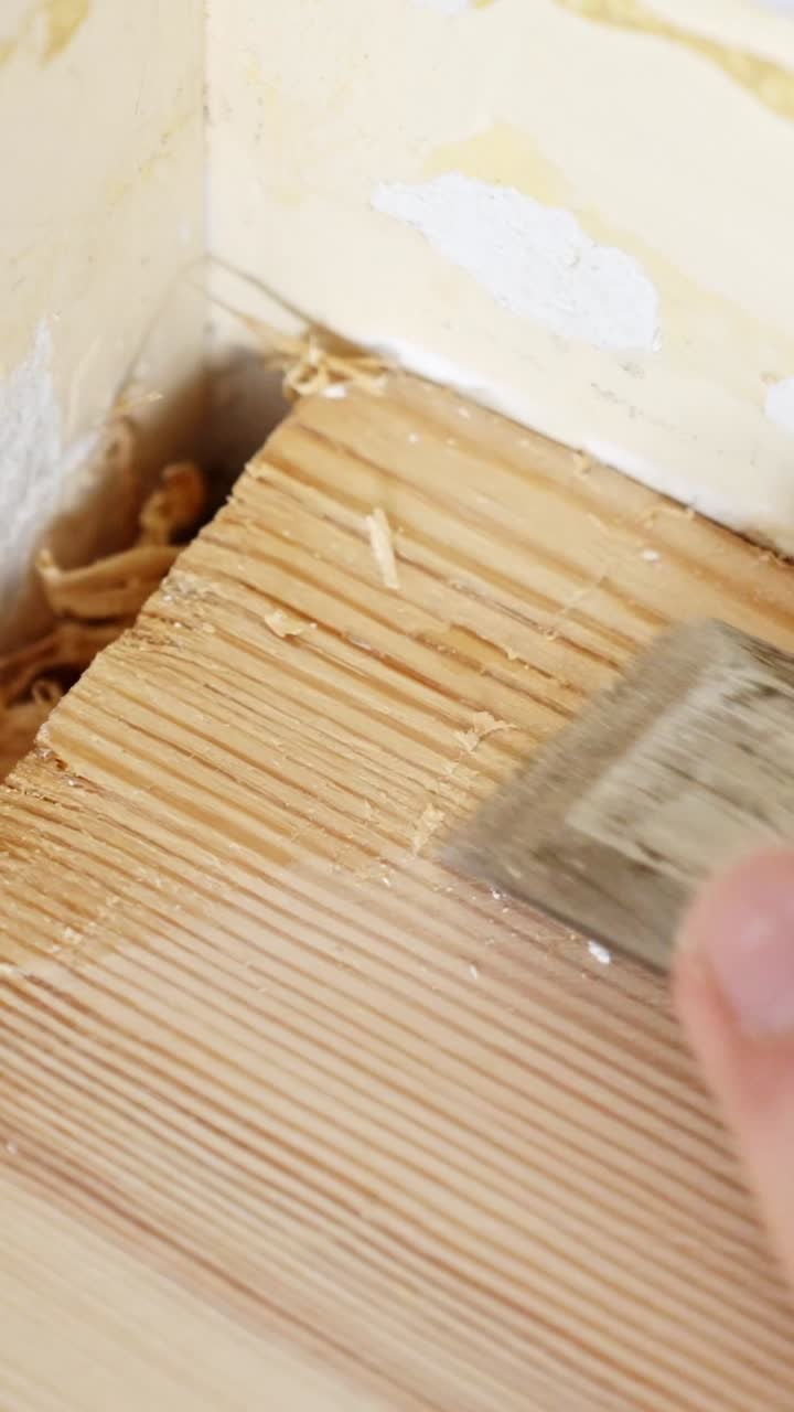 Detailed vertical view of cutting the top layer of a wooden floor during a DIY renovation
