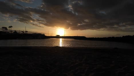 sunset sun over ocean in tenerife canary island los cristianos south view from beach