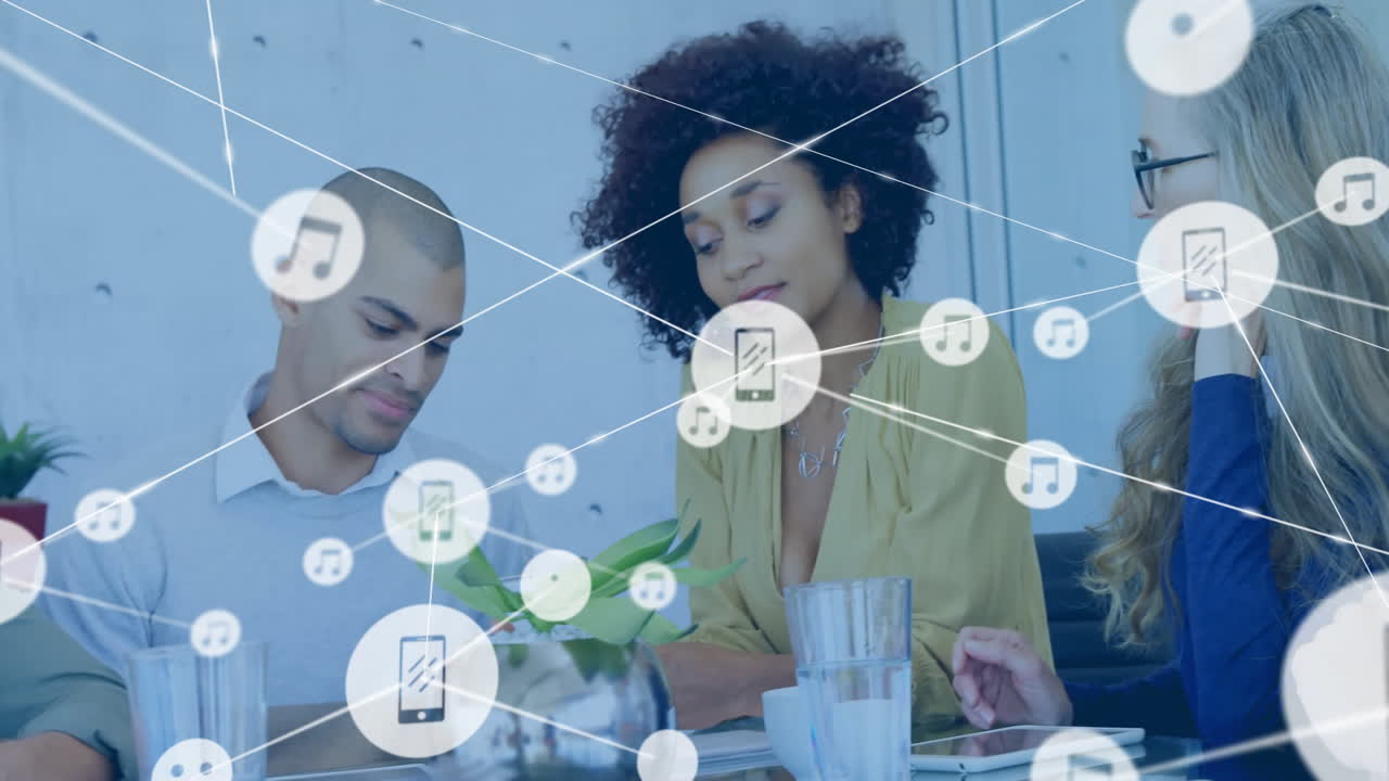 Animation of network of connections with icons over diverse colleagues having meeting in office