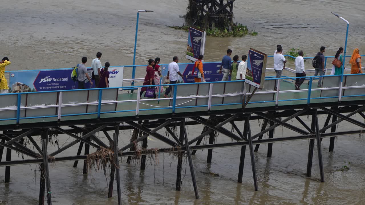 People are boarding the ship from the wharf.