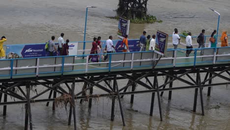 people are boarding the ship from the wharf.