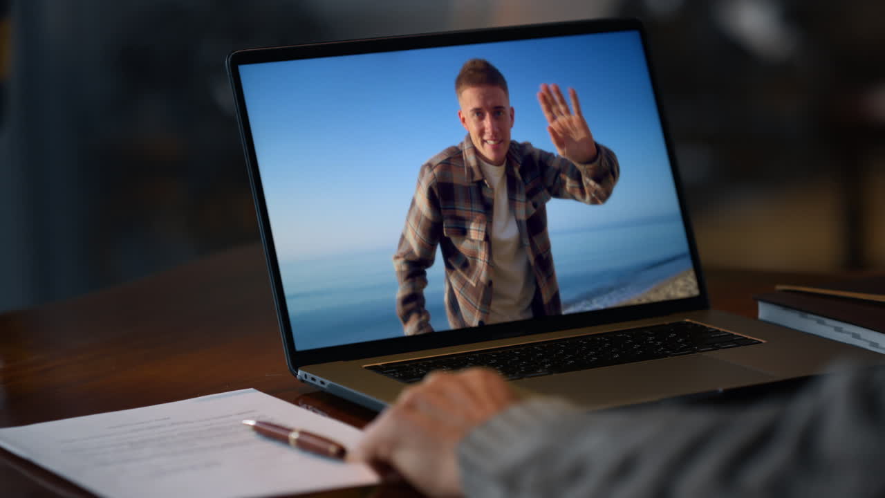 A laptop displaying a video call