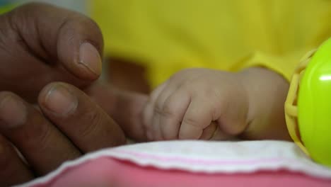 a kid hand holds the father's finger. raising children in the family, taking care of children.close-up of a kid's hand. concept of family planning.a newborn child holds his father's hand
