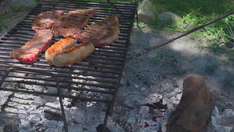 argentinian barbecue, tradicional asado. tidying up the embers