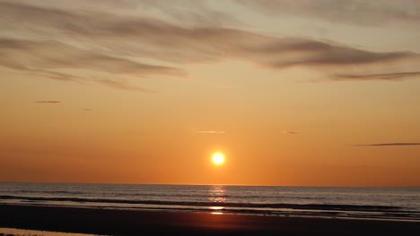 Man-running-with-guitar-in-back-sand-beach-at-sunset-31