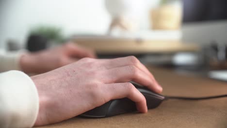 guy using the mouse of his computer to click and scroll