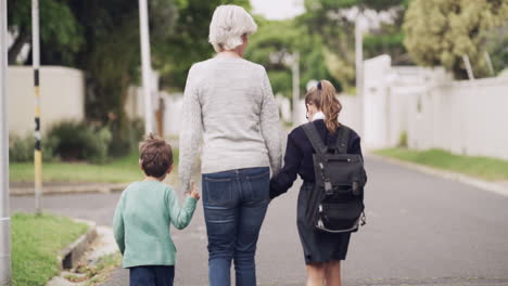 a-senior-woman-walking-her-grandchildren-home