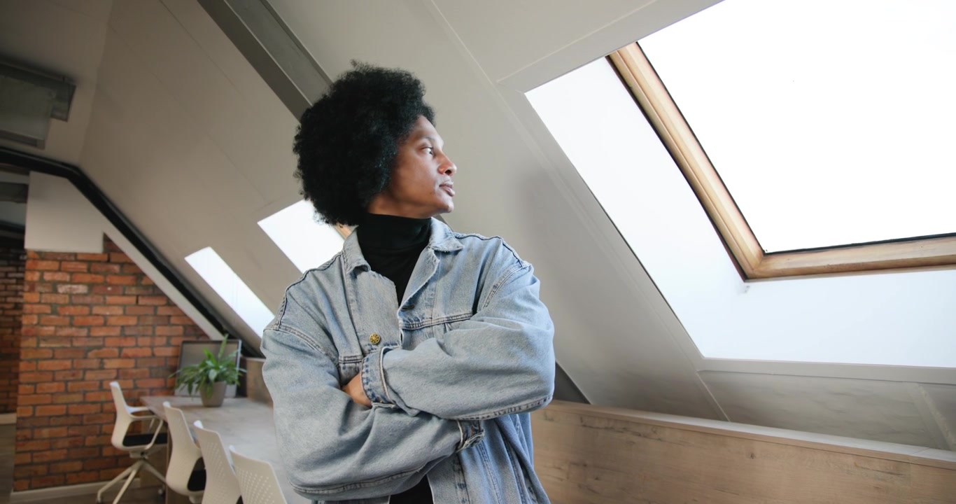 African-American man leaning by bench checking phone glancing skylight as camera moving, copy space