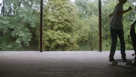 caucasian boy skateboarding in a ruined building.