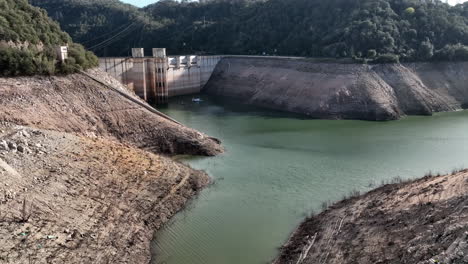 aerial view flying towards sau reservoir with river ter water resource in low supply, catalonia