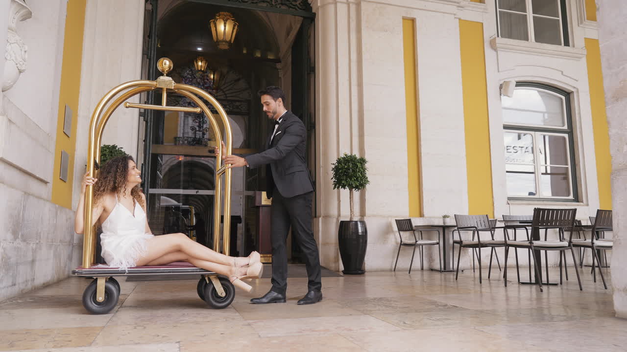 Hotel Porter Assisting Couple with Luggage