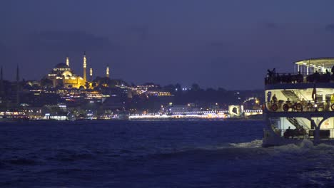 night sea view of ferry and mosque.