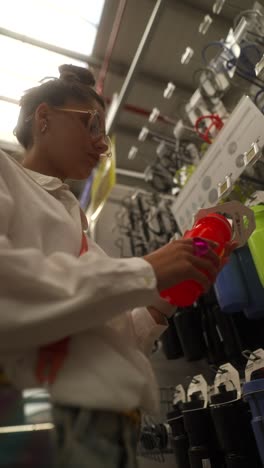 woman shopping for water bottles in a store