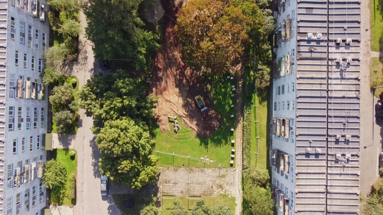 Rooftop of old Soviet built apartment buildings and small construction site, aerial top down view