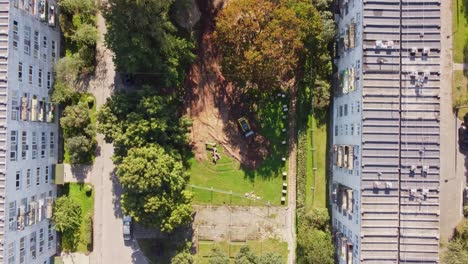 rooftop of old soviet built apartment buildings and small construction site, aerial top down view