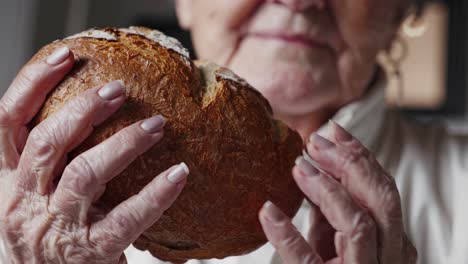 elderly woman holding bread