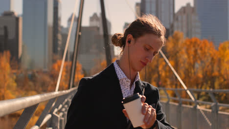 Man-having-coffee-while-standing-on-the-bridge-4k