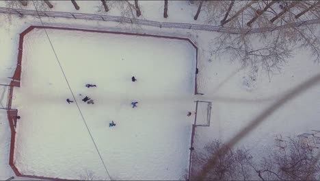 kids playing ice hockey on a snowy playground