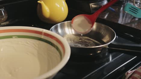 Scooping-The-Remaining-Pancake-Batter-Into-Skillet---Close-Up-Shot