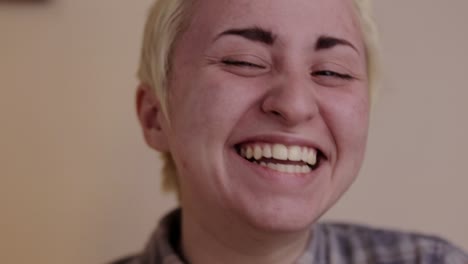 a young person laughing in front of the camera