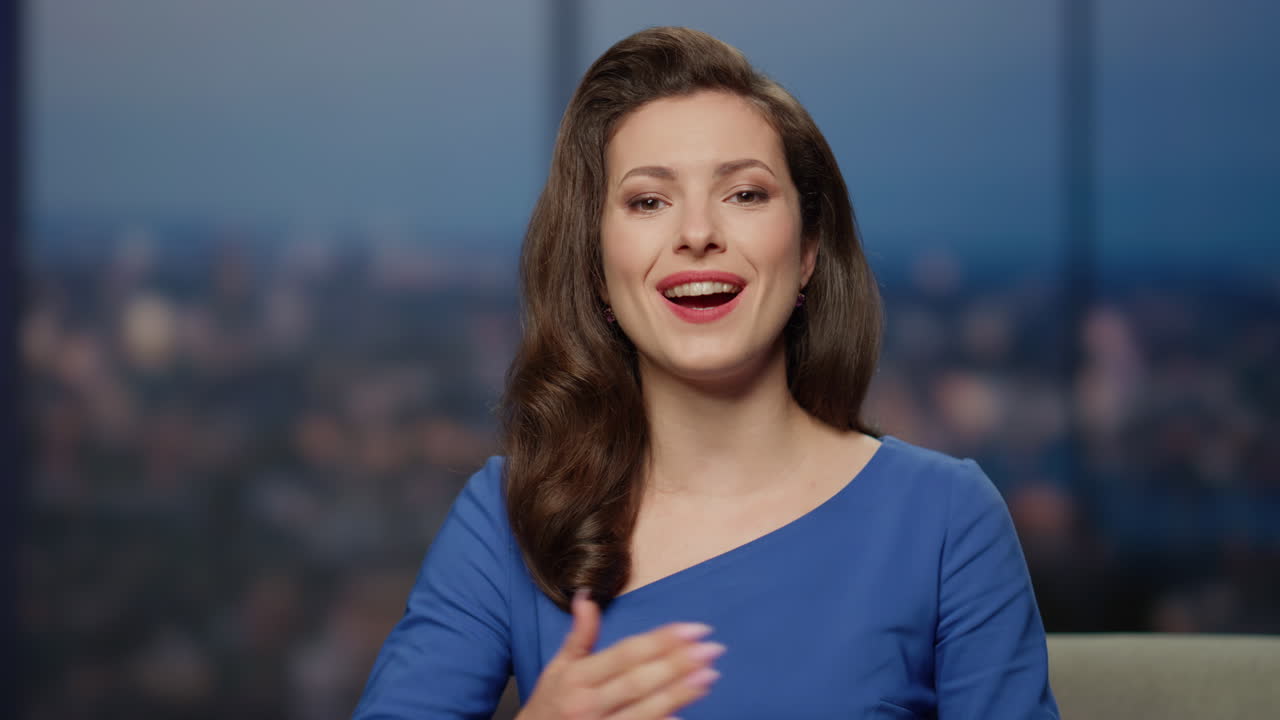 Happy anchor woman talking on television studio presenting man guest closeup