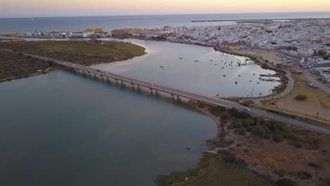 aerial view of the barbate river reaching the sea and a bridge over it.