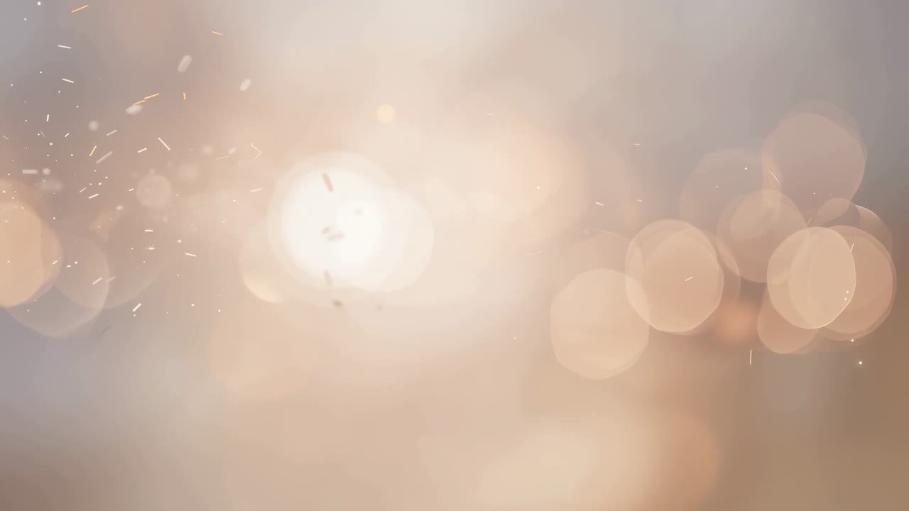 Appearing small bright orb initiating warm central flare in studio, radiating bokeh and sparks