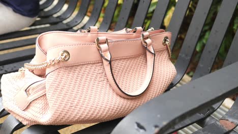 Women-left-her-hand-bag-on-the-beach,