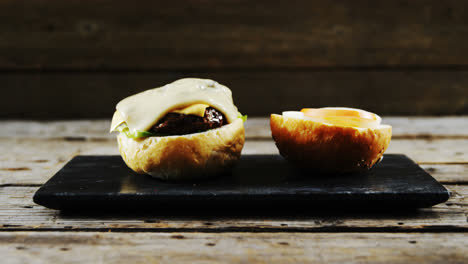 melted cheese falling over hamburger on tray