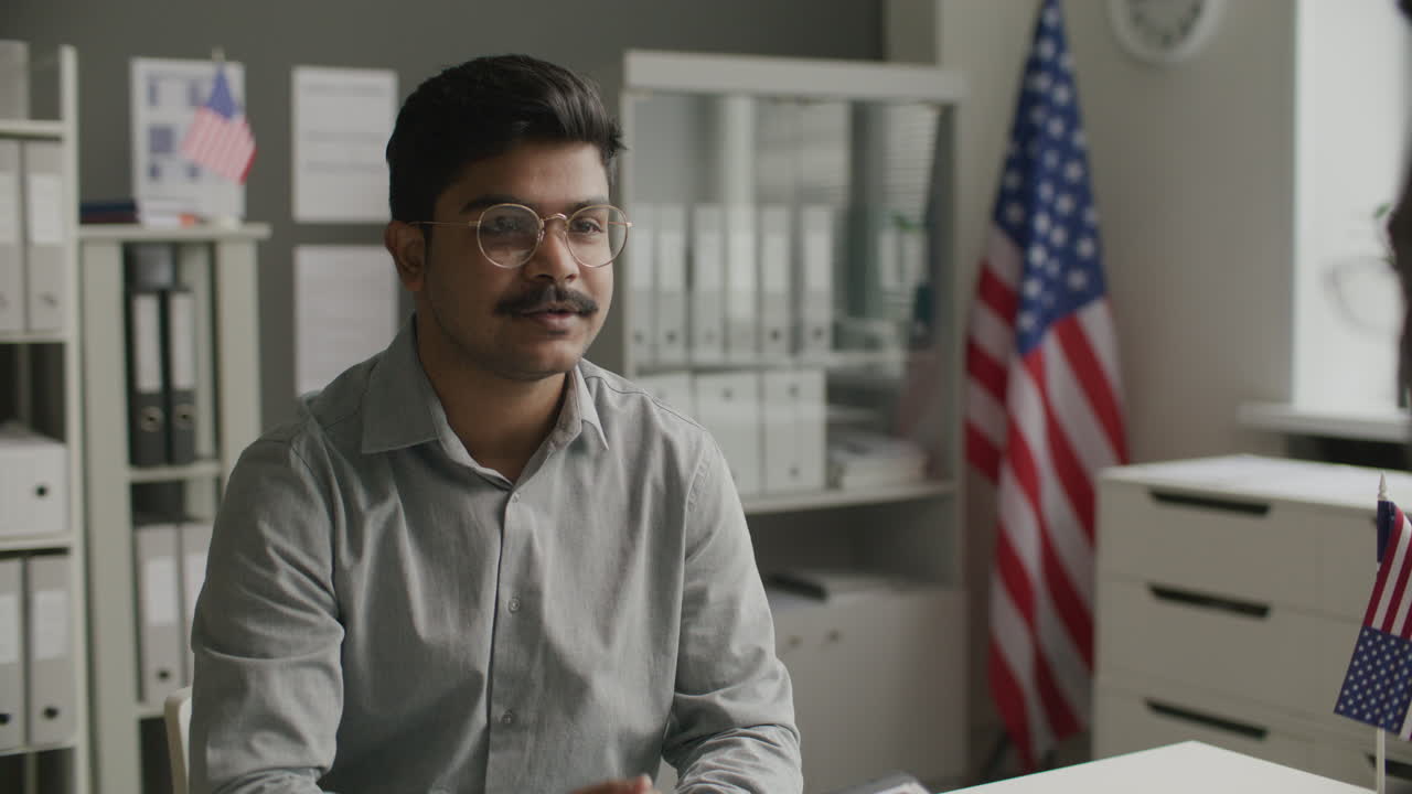Immigration Officer Interviewing Indian Man Applying for US Visa