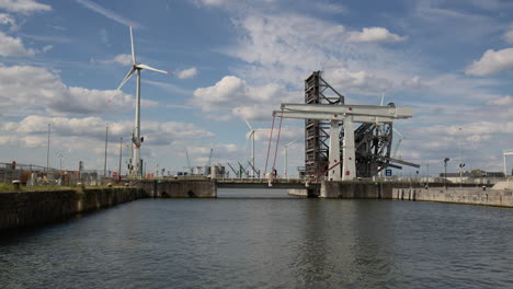 wind turbines and the building of lillo bridge at the port of antwerp, belgium - wide shot