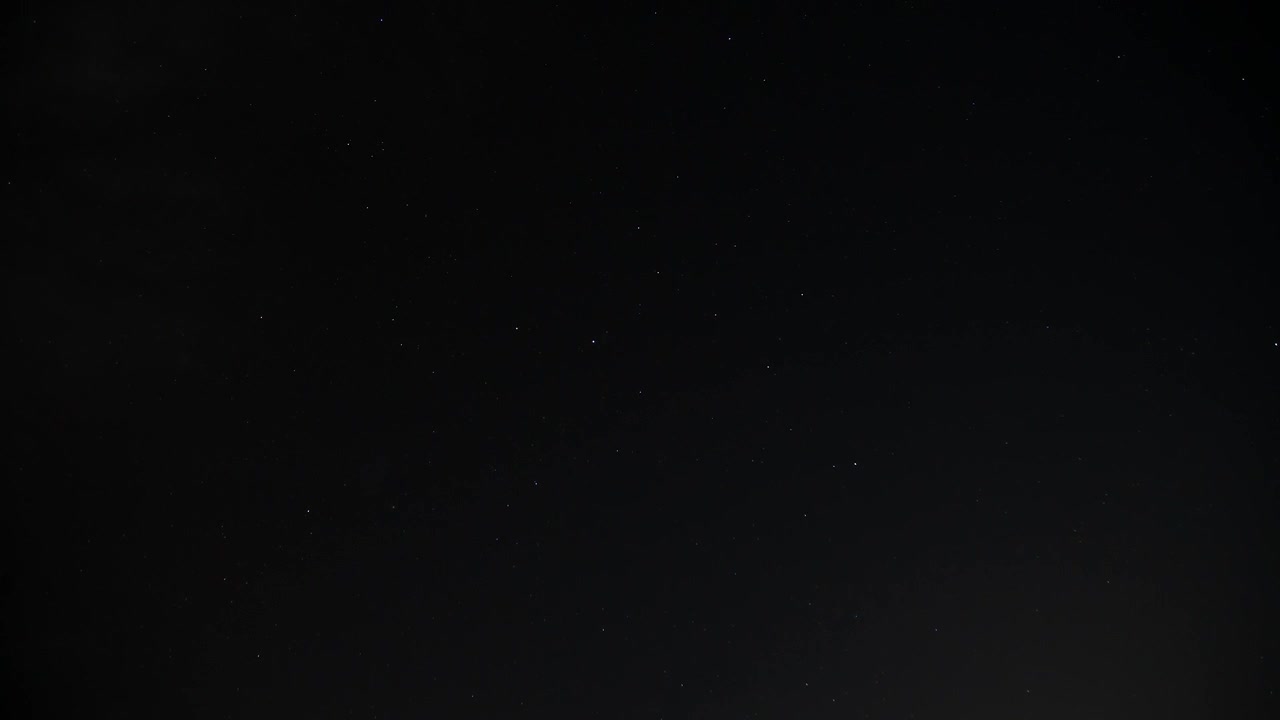 Time Lapse of clouds rolling by to reveal a starry night, wide 4K