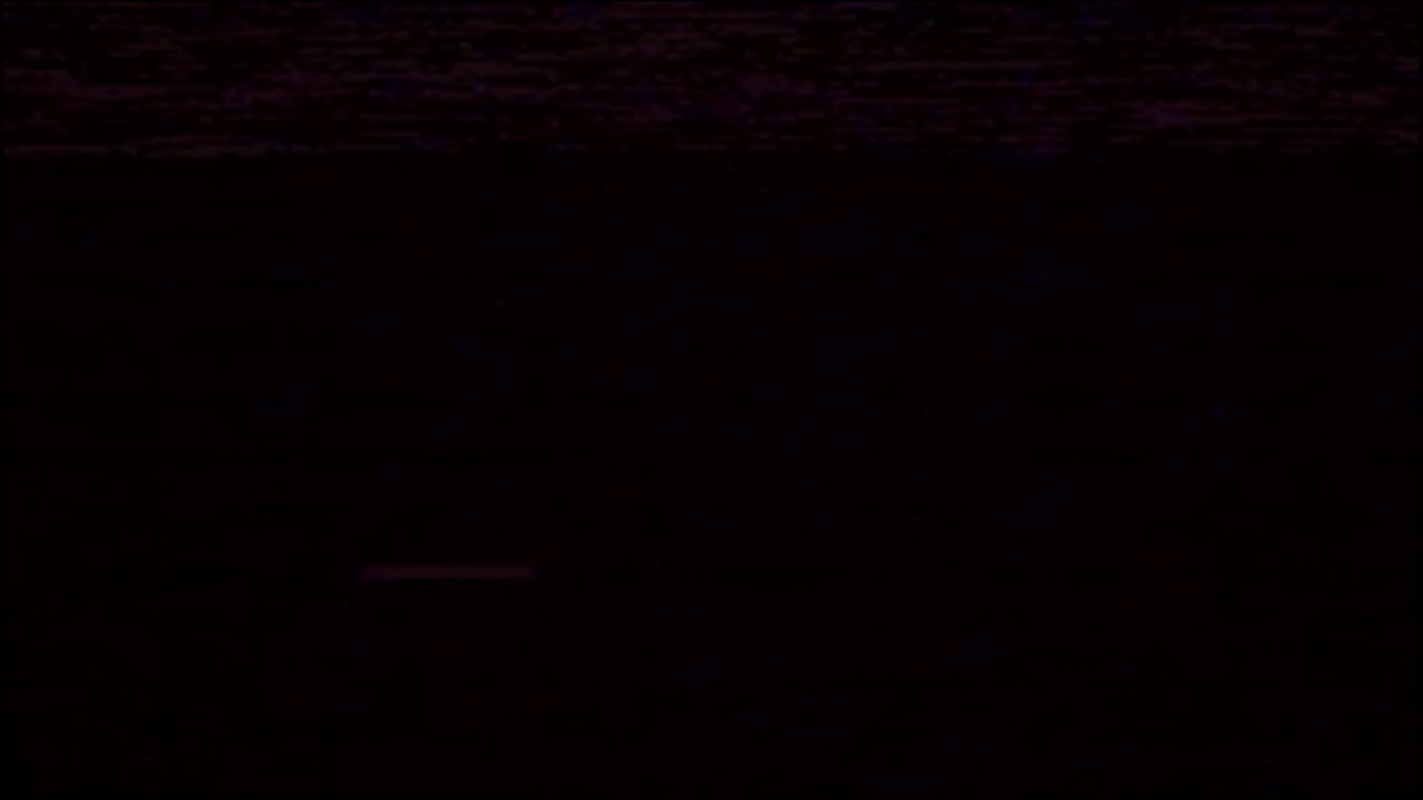 Authentic vhs tape noise with subtle static and glitches on a dark, faded screen. Perfect overlay for creating a retro 80s or 90s look