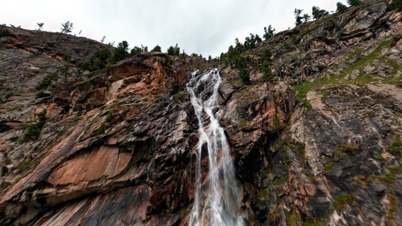 Stunning waterfall near Morteratsch Glacier in serene mountain landscape