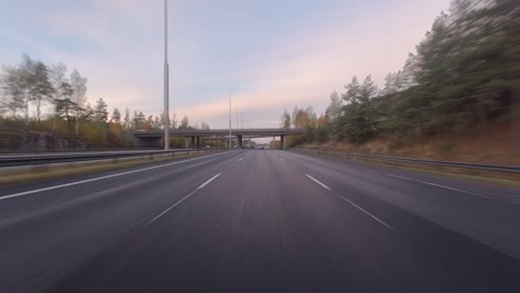 colourful autumn highway drive pov: driving under several overpasses