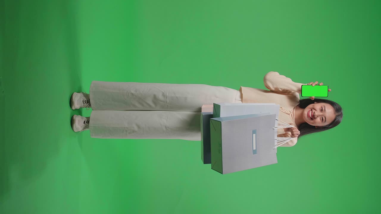 Woman Shopping with Smartphone and Bags on Green Screen