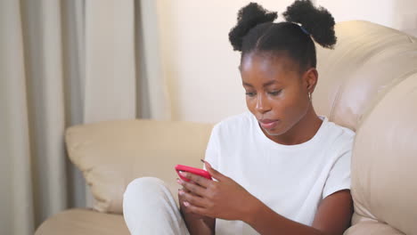 young woman using smartphone on couch