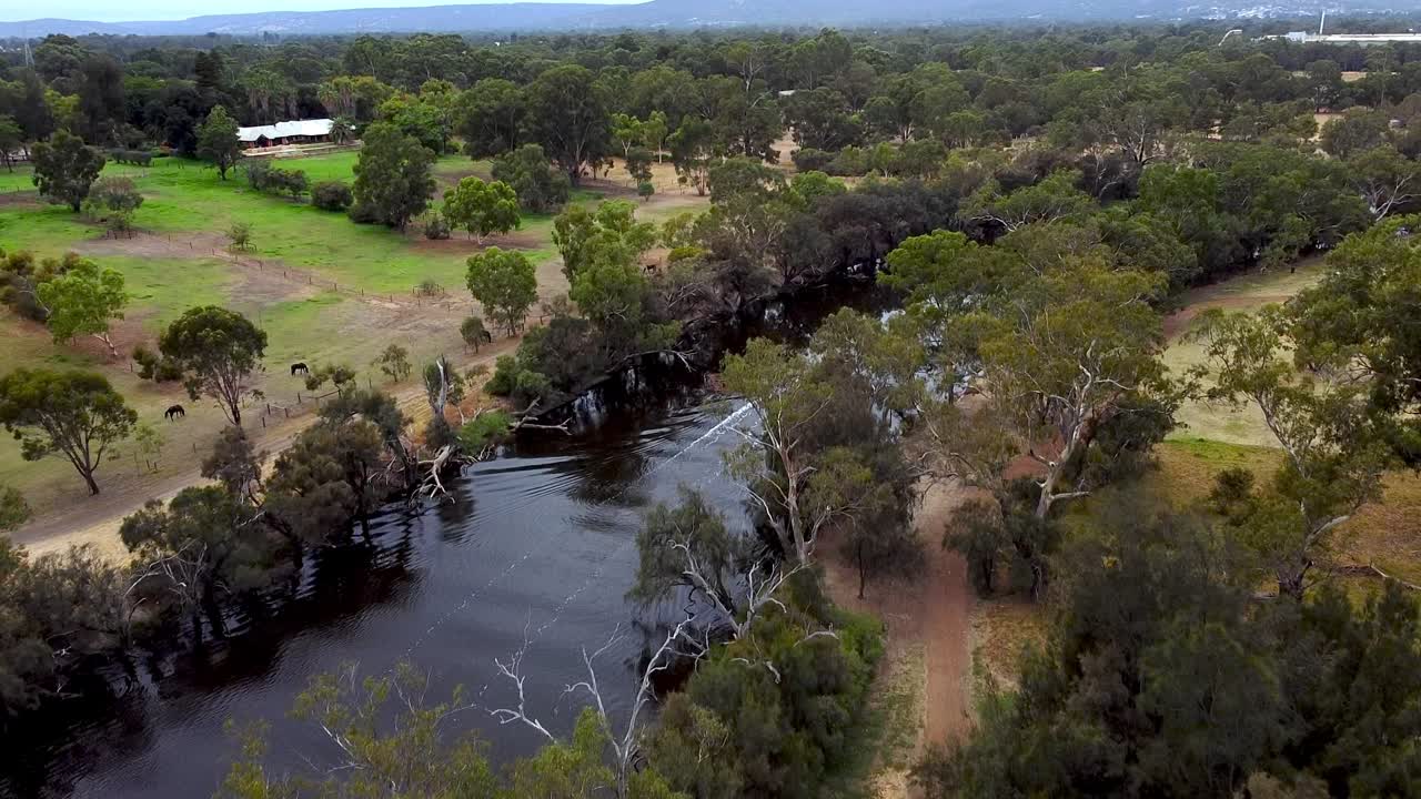Bird&rsquo;s eye view of a small speedboat traveling along a narrow river