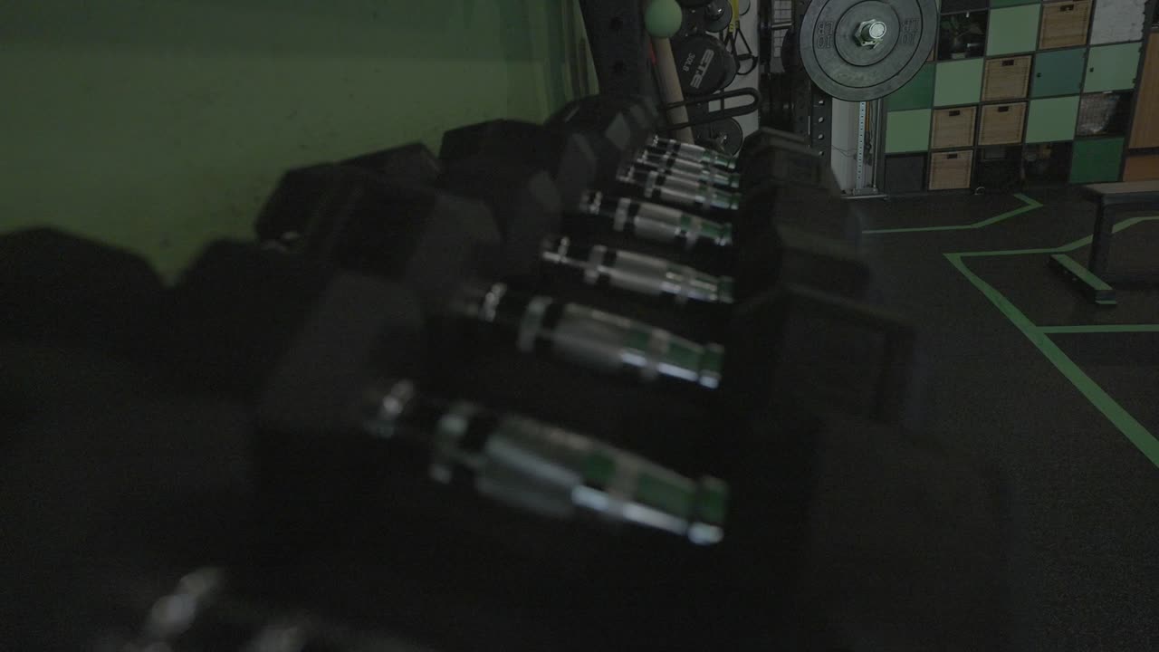 A rack of dumbbells inside of a gym