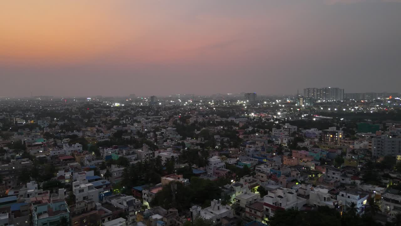 A sweeping night shot of a sprawling city. The illuminated streets and buildings create a dynamic, shimmering pattern. Ideal for capturing urban energy and population density. in Chennai City