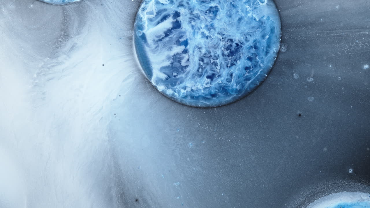 Swirling blue ink bubbles in macro, abstract liquid art with dreamy mood and texture