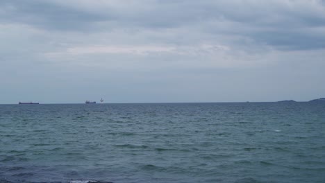 cargo ships in the distance of the ocean horizon