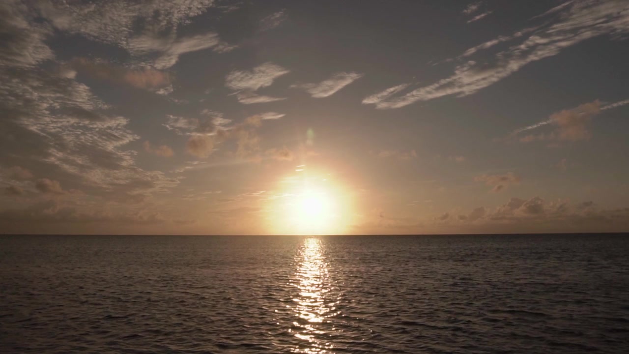 Coastal beach sunrise in South Florida with clouds and ocean.