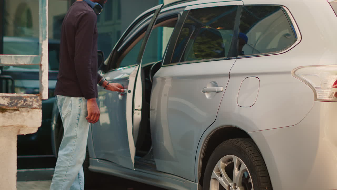 Man getting into car
