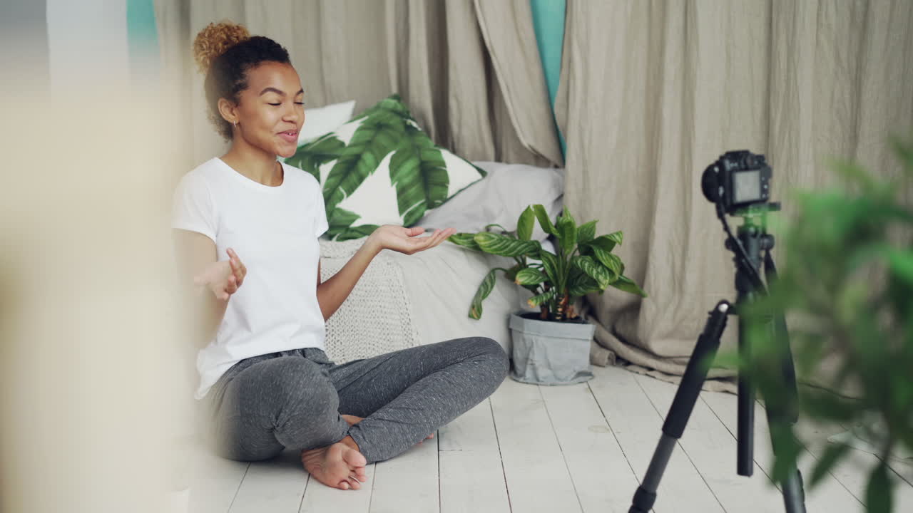 Woman Recording a Video Blog in Her Bedroom