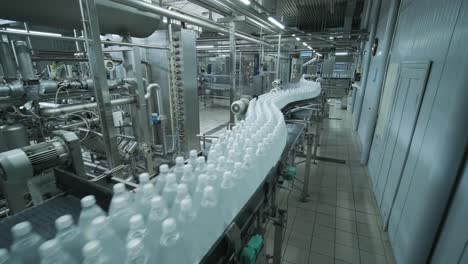 conveyor belt with bottles of drinking water at a modern beverage plant