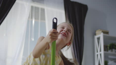 A Little Girl Having Fun With a Mop