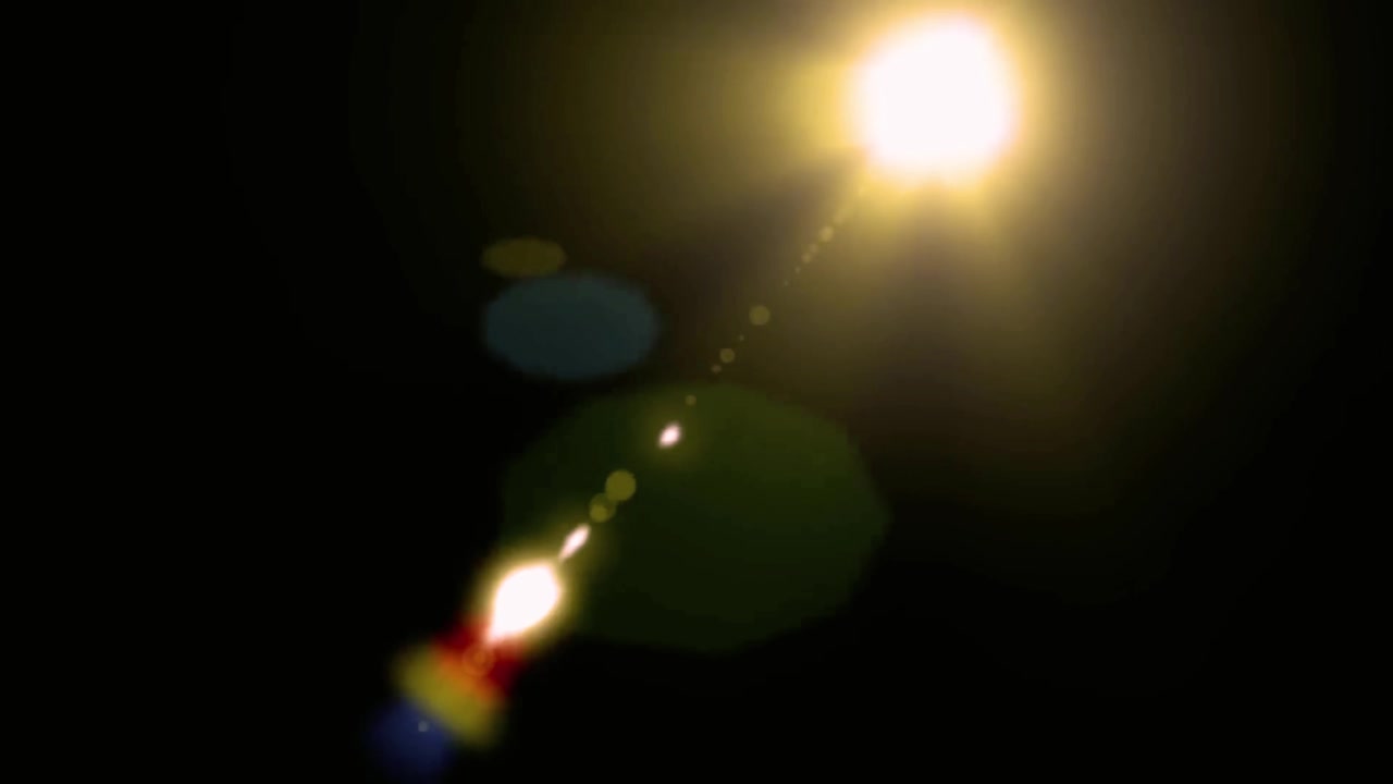 Bright Golden Lens Flare Moving Across Black Background