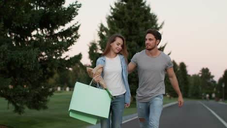 happy couple in love enjoying walk in summer park. romantic couple outdoor