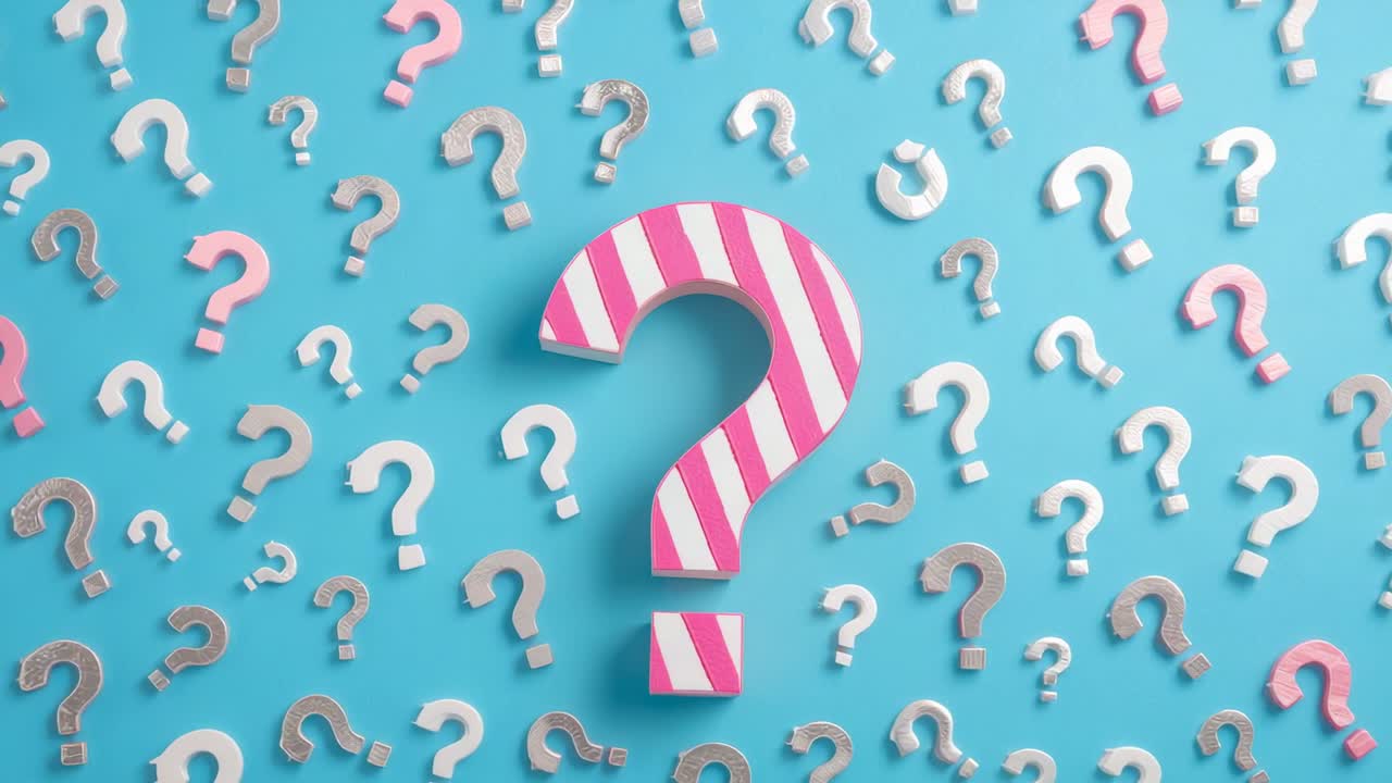 Playback starting displaying pink-white question mark on blue backdrop with question mark pattern